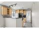 Kitchen area with breakfast bar and light wood cabinets at 6380 S Boston St # 397, Greenwood Village, CO 80111