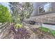 Landscaped backyard with mature trees, rock features, and a tranquil water feature at 1495 W 137Th Ave, Broomfield, CO 80023