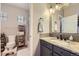 Bathroom vanity with marble countertop and sink and shower and toilet in background at 1495 W 137Th Ave, Broomfield, CO 80023