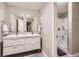 Modern bathroom with double sink vanity, large mirror, and walk-in shower at 1495 W 137Th Ave, Broomfield, CO 80023