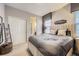 Bedroom featuring a large bed with a padded headboard, window, and closet at 1495 W 137Th Ave, Broomfield, CO 80023