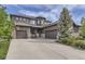 Beautiful home with a three-car garage, stone accents, and mature landscaping at 1495 W 137Th Ave, Broomfield, CO 80023