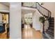 Elegant foyer with hardwood floors, wrought iron staircase, and views into the living room at 1495 W 137Th Ave, Broomfield, CO 80023