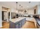 Gourmet kitchen featuring a center island with white marble countertops and stainless steel appliances at 1495 W 137Th Ave, Broomfield, CO 80023