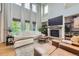 Bright living room with soaring ceilings, large windows, and a stone fireplace at 1495 W 137Th Ave, Broomfield, CO 80023