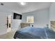 Modern bedroom with a mounted TV, a large window, and a door that leads to a walk-in closet at 6829 Juniper Ct, Frederick, CO 80530