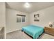 Bright bedroom with a large window, soft carpeting, and simple, modern decor at 6829 Juniper Ct, Frederick, CO 80530