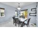 Bright dining room with a modern light fixture and a view of the backyard at 6829 Juniper Ct, Frederick, CO 80530