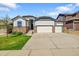 Charming ranch-style home featuring a three-car garage, stone accents, and a well-manicured front lawn at 6829 Juniper Ct, Frederick, CO 80530