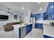 Bright, eat-in kitchen features stainless appliances, a marble island, and blue cabinets at 6829 Juniper Ct, Frederick, CO 80530