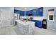 Modern kitchen with blue cabinets, a marble island, and stainless steel appliances at 6829 Juniper Ct, Frederick, CO 80530