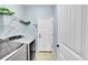 Convenient laundry room with modern washer and dryer, plus storage shelves at 6829 Juniper Ct, Frederick, CO 80530
