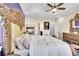 Opulent main bedroom features a large bed with an ornate headboard and fireplace at 6829 Juniper Ct, Frederick, CO 80530
