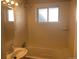 Cozy bathroom with tiled tub, mirror and updated vanity and fixtures at 2101 S Lowell Blvd, Denver, CO 80219