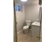 Cozy bathroom with neutral paint, a new toilet, new vanity, and tiled floor at 2101 S Lowell Blvd, Denver, CO 80219