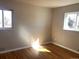 A bright bedroom featuring wood floors and two windows offering natural light at 2101 S Lowell Blvd, Denver, CO 80219