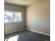 A cozy bedroom featuring soft gray carpet and a window offering natural light at 2101 S Lowell Blvd, Denver, CO 80219