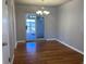 Dining room with hardwood floors and a chandelier, next to sliding doors to the yard at 2101 S Lowell Blvd, Denver, CO 80219