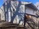 Exterior view of home with garage door, fenced yard and easy access white door at 2101 S Lowell Blvd, Denver, CO 80219