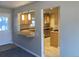 Open kitchen area featuring warm wood cabinets, a breakfast bar, and modern appliances at 2101 S Lowell Blvd, Denver, CO 80219