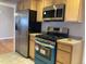 Modern kitchen with stainless steel appliances and light wood cabinets at 2101 S Lowell Blvd, Denver, CO 80219