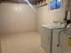 Basement laundry room with washer, dryer, and storage space, offering convenience and functionality at 2101 S Lowell Blvd, Denver, CO 80219