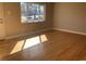 Bright living room with hardwood floors and natural light from a large window at 2101 S Lowell Blvd, Denver, CO 80219