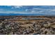 Expansive aerial view of a tranquil neighborhood with a scenic lake and distant mountain views at 3849 E 121St Ave, Thornton, CO 80241