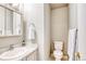 Half bath features tiled walls, a modern sink, and a toilet at 3849 E 121St Ave, Thornton, CO 80241