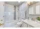 Clean bathroom features a tiled shower-tub, white vanity and modern fixtures at 3849 E 121St Ave, Thornton, CO 80241