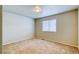 Bedroom featuring neutral paint and carpet, with a large window providing natural light at 3849 E 121St Ave, Thornton, CO 80241