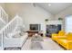 Bright living room features vaulted ceilings, a cozy fireplace, and an open staircase at 3849 E 121St Ave, Thornton, CO 80241