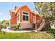 This home features a well-maintained lawn, mature trees, and a charming deck with steps at 19595 Mitchell Dr, Denver, CO 80249