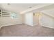 Finished basement area with closet, carpeting, and access to another room with natural light at 19595 Mitchell Dr, Denver, CO 80249