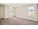 Bright bedroom with two windows and neutral carpeting for a cozy and inviting space at 19595 Mitchell Dr, Denver, CO 80249