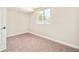Cozy bedroom featuring neutral carpeting and ample natural light from a large window at 19595 Mitchell Dr, Denver, CO 80249