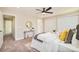 Sunlit bedroom boasts a modern interior, soft carpet, and a comfortable bed with stylish decorations at 19595 Mitchell Dr, Denver, CO 80249