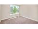 Inviting bedroom with plush carpeting, a large window offering natural light, and simple, stylish decor at 19595 Mitchell Dr, Denver, CO 80249