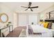 Bright bedroom showcasing plush carpet, white closet doors, and a comfortable bed with decorative pillows at 19595 Mitchell Dr, Denver, CO 80249