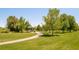 Well-maintained community park with a covered gazebo, walking path, and lush greenery at 19595 Mitchell Dr, Denver, CO 80249