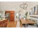 Open concept dining room with stainless refrigerator and view into living room at 19595 Mitchell Dr, Denver, CO 80249