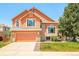 Charming two-story home featuring a well-maintained lawn, attached two-car garage and inviting facade at 19595 Mitchell Dr, Denver, CO 80249