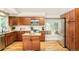 Charming kitchen with wood cabinets, granite countertops, stainless steel appliances, and a cozy breakfast nook at 19595 Mitchell Dr, Denver, CO 80249