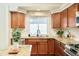 A well-lit kitchen with granite countertops, stainless steel appliances, and light tile backsplash at 19595 Mitchell Dr, Denver, CO 80249