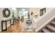 Sunlit living room featuring a vaulted ceiling, hardwood floors, stylish furnishings, and an open staircase at 19595 Mitchell Dr, Denver, CO 80249