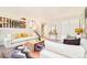 Living room with neutral furniture, decor, and view of kitchen and stairway at 19595 Mitchell Dr, Denver, CO 80249