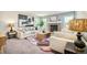 Cozy living room featuring neutral furniture, a brick fireplace, and large windows at 19595 Mitchell Dr, Denver, CO 80249