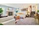 Bright living room with a brick fireplace, stairs, neutral furniture, decor, and laundry area at 19595 Mitchell Dr, Denver, CO 80249