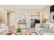 Comfortable living room with laundry area, neutral decor and furniture plus stairway at 19595 Mitchell Dr, Denver, CO 80249