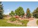 Community playground area with climbing equipment and slides near green grass and trees at 19595 Mitchell Dr, Denver, CO 80249